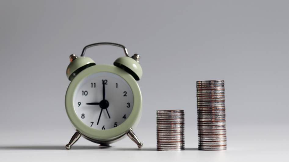 Coins stacked by a clock - Wage Disputes